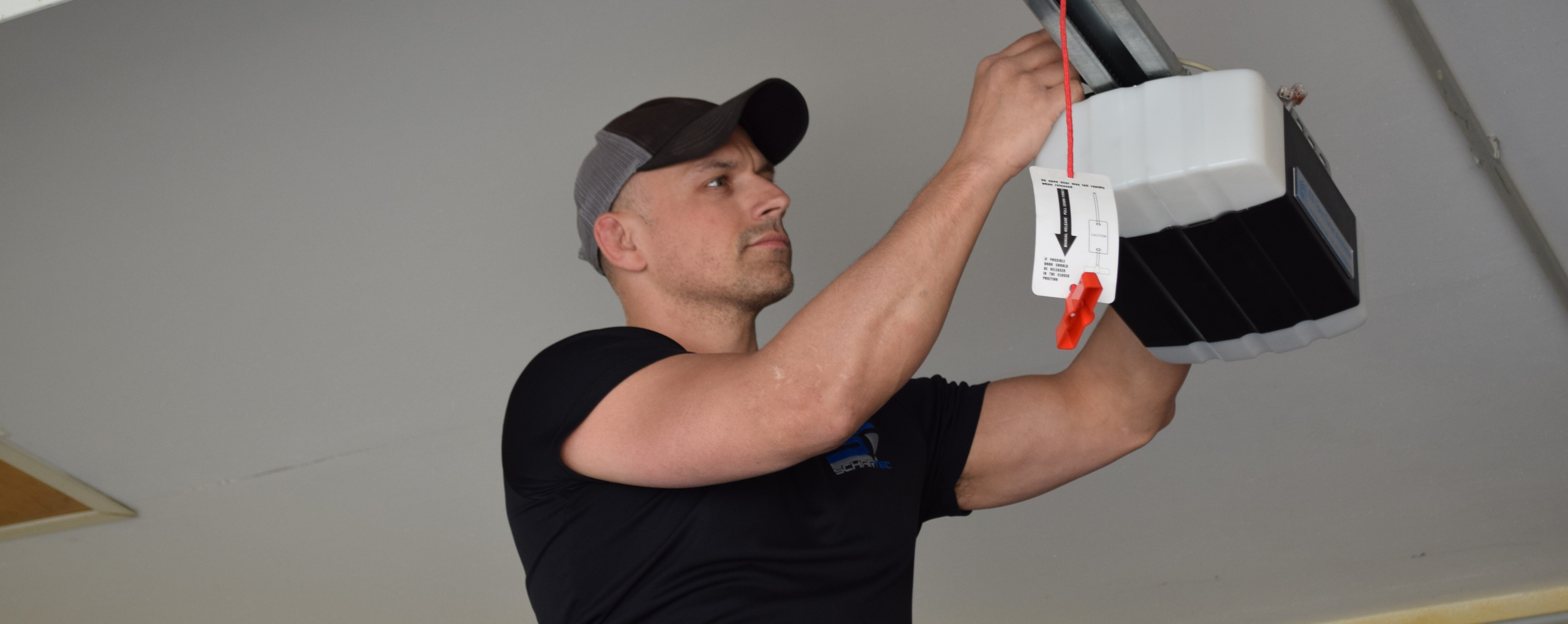 CEO Patrick Wilson installing a garage door opener